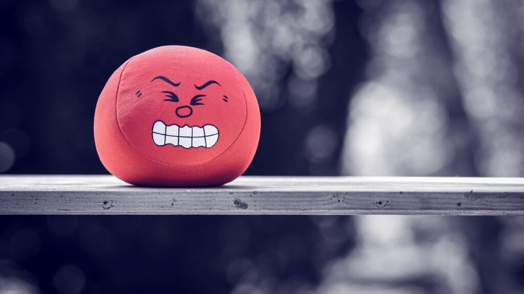 Red stress ball with angry expression